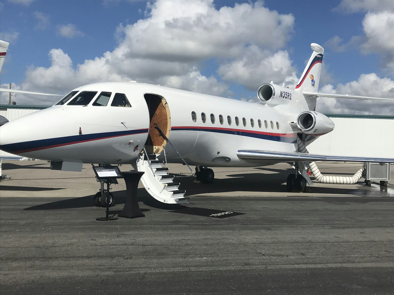 Private jet on the tarmac with airstair deployed, ready for boarding